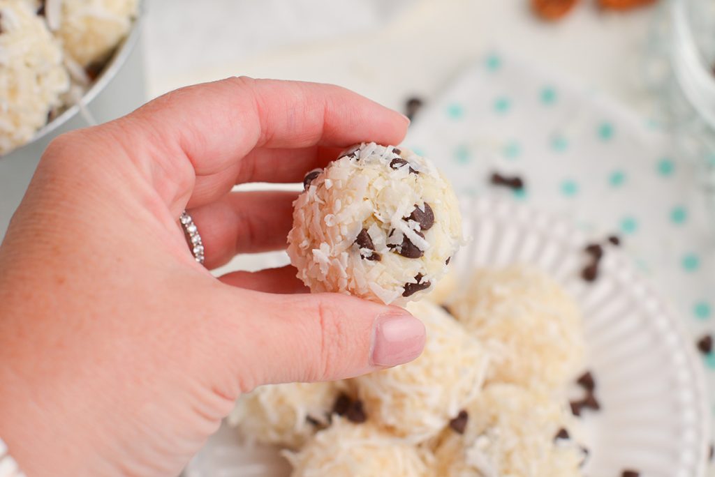 hand holding no-bake coconut ball